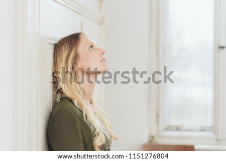 Similar – Image, Stock Photo Woman leaning against door in front of red wall