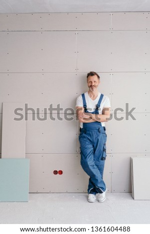 Similar – Image, Stock Photo Smiling workman in denim overall looking at camera