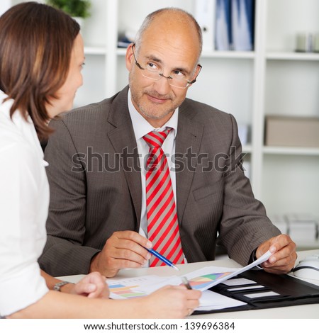 businessman looking at female colleague in meeting