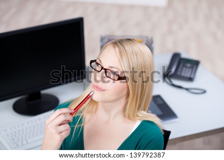 High angle view of young businesswoman thinking at office desk