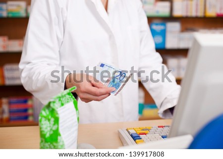 Paying For Medicine Using Cash At Pharmacy