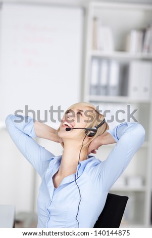 happy woman using headset folding hands behind head