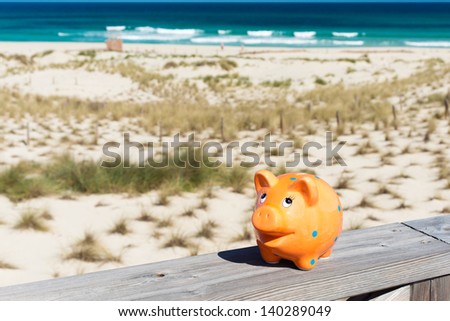 piggybank standing on stage by the beach