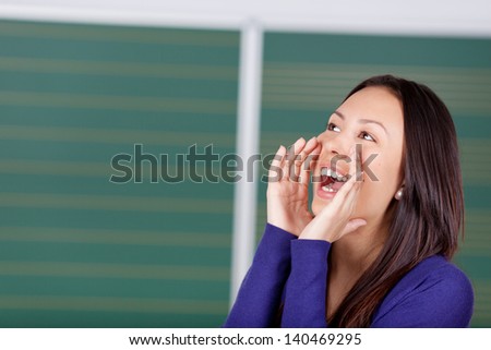 female student with hands on her mouth shouting loud
