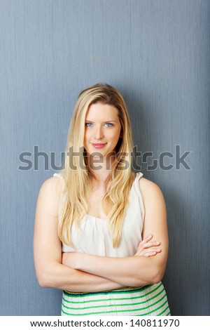self-confident woman with folded arms and blond hair