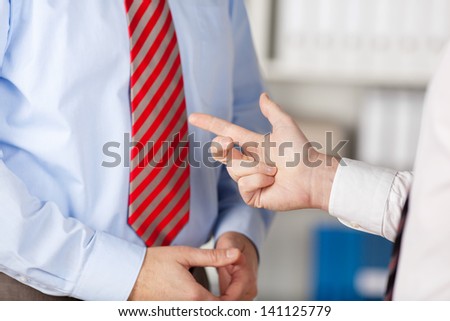 Human hand pointing his business partner in a close up shot