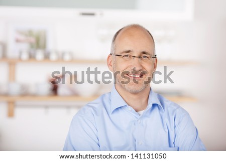 Portrait of smiling bald man at home background