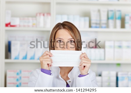 Close portrait of pharmacist chemist woman covering her mouth with black paper