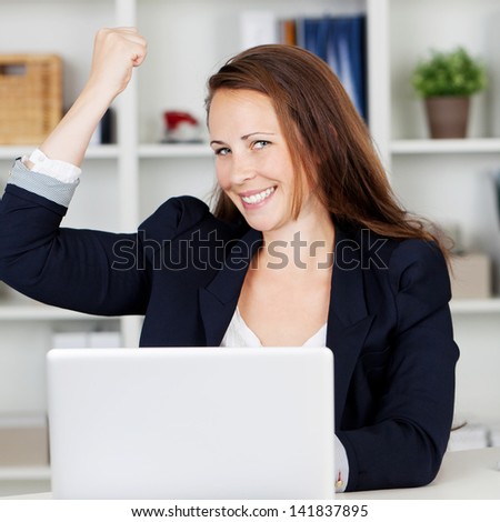 Image of a happy female executive expressing her joy after achieve her targets.