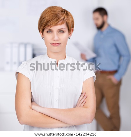 closeup portrait of businesswoman with co worker in background at office