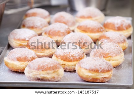 Sweet fried pastry on baking sheet in bakery