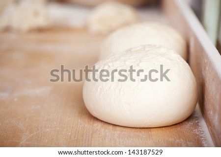 Close up bread dough on wooden bakery table