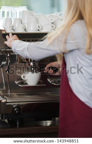 close-up view of woman\'s hands brewing a cup of coffee