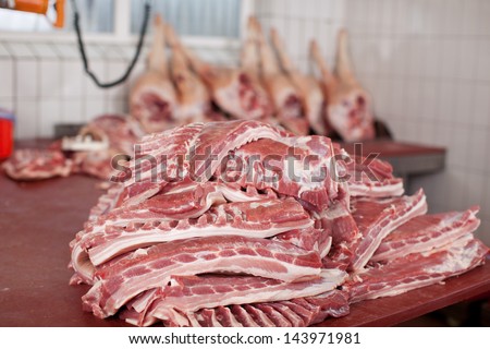 pieces of meat lying on table in cold room