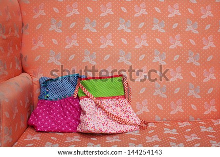 Closeup of designer bags on sofa