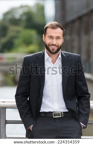 Attractive Smiling Young Man in Corporate Attire Outside the Building. Looking at Camera.