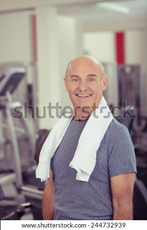 Close up Happy Healthy Old Bald Man, with Towel at his Shoulder, at the Fitness Gym.