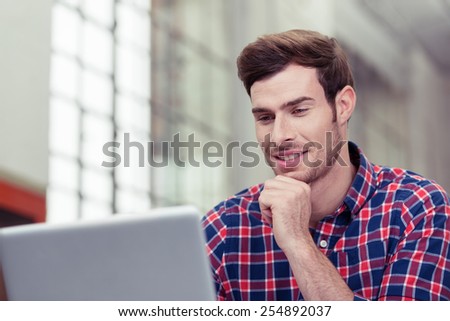 Close up Young Handsome Man in Checkered Shirt Chatting to Someone Using Laptop Computer
