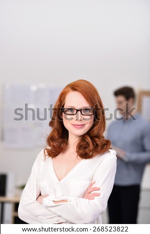 Close up Confident Pretty Office Woman with Wavy Brown Hair Looking at the Camera Inside the Office.