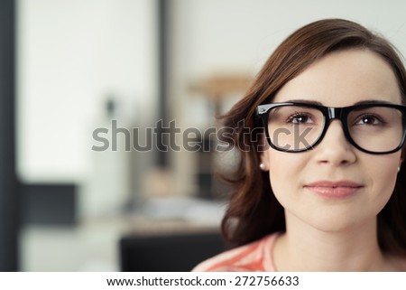 Close Up of Young Brunette Woman Wearing Eyeglasses with Black Frames Looking Up Optimistically as if Daydreaming or Thinking of Something Inspirational