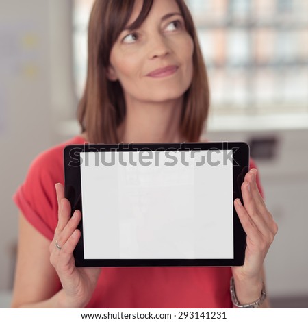 Close up Thoughtful Woman Holding her Tablet Computer While Showing the Empty White Screen at the Camera, Emphasizing Copy Space.