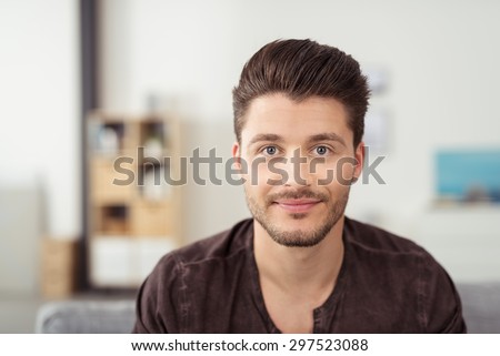 Portrait of a Handsome Young Bearded Guy Looking at the Camera with a Happy Facial Expression.