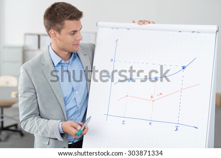Handsome Young Businessman Showing his Conceptual Business Graph on a Poster Paper While Holding a Marker Pen.