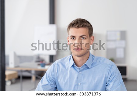 Close up Handsome Young Businessman Inside the Office, Looking at the Camera with a Smiling Face.