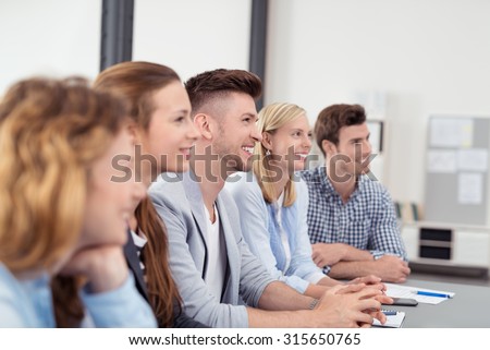 Young Office People with Happy Facial Expressions Listening to Someone Discussing to them Inside the Office