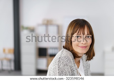 Head and Shoulder Shot of an Adult Office Woman Looking at the Camera with Half Smile Face.