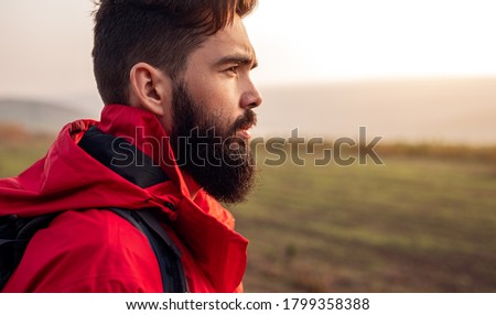 Similar – Image, Stock Photo Crop traveler with trekking poles in mountains in winter