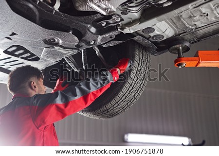 Similar – Image, Stock Photo Busy male mechanic repairing motorcycle seat in workshop