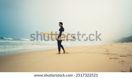 Image, Stock Photo Surfer standing at the beach with surfboard