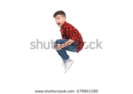 Side view of excited young boy jumping isolated on white.  ストックフォト © 