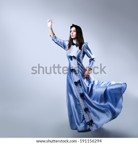 Full Length Portrait of a Woman Reaching for the Light in Waving Purple Dress. Copy Space.