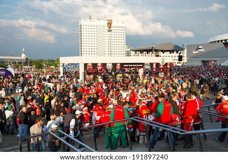 MINSK, BELARUS - MAY 9 - Belarussian, Swiss and Russian Fans with Flags in Front of Minsk Arena on May 9, 2014 in Belarus. Ice Hockey World Championship (IIHF) Opening.