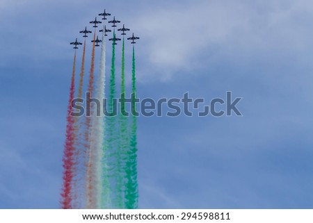 Ostia, Rome / Italy - June 29th 2014: Frecce Tricolori: italian aerobatic Team drawing italian flag with colors smokes in triangle formation at Ostia International Airshow 2014