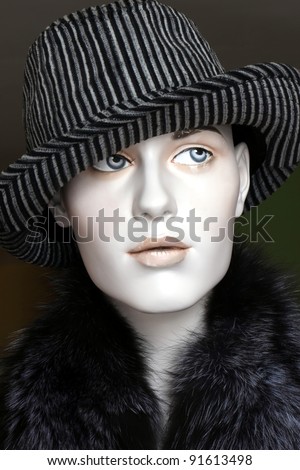 female mannequin wearing a fedora hat and fur collar