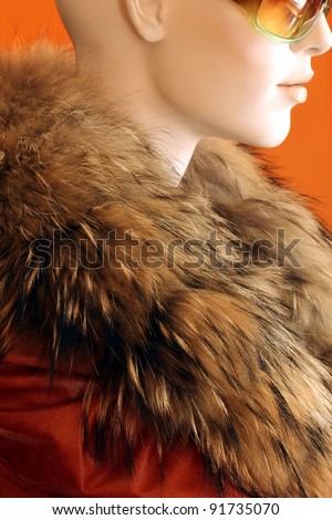 mannequin wearing fur and leather coat and sunglasses