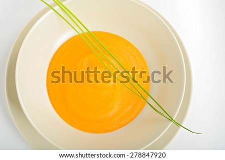 Delicious healthy pumpkin soup in a light dish. View from above, macro