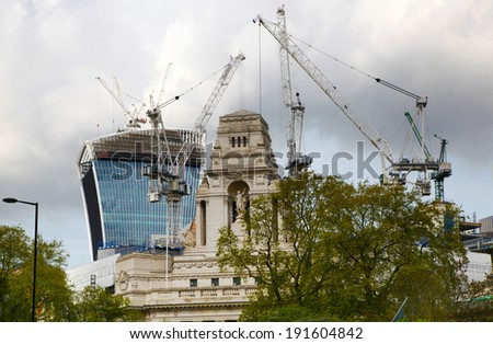 LONDON, UK - APRIL 24, 2014: Building contraction with cranes in the City of London one of the leading centres of global finance.