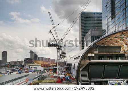 LONDON, UK - APRIL 24, 2014: Building site with cranes Canary Wharf aria, one of the leading centres of global finance, headquarters for leading banks, insurance, stock exchange, media businesses