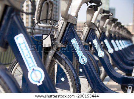 LONDON, UK - MAY 7, 2014: Boris bikes parking on business Canary Wharf aria, sponsored by Barkley\'s bank. Popular city transport among Londoners