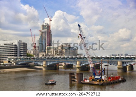 LONDON, UK - JUNE 30, 2014: London view from the bridge with building site and cranes