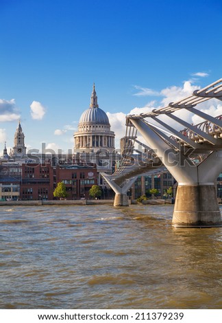 LONDON, UK - AUGUST 9, 2014:  South bank walk of the river Thames. St. Paul\'s cathedral. View on bridge and modern architecture