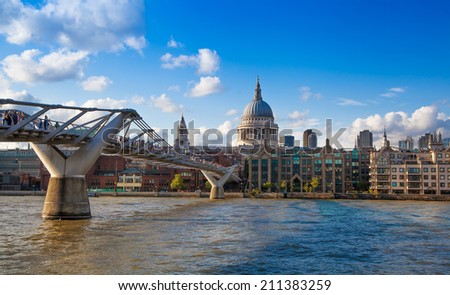 LONDON, UK - AUGUST 9, 2014:  South bank walk of the river Thames. St. Paul\'s cathedral. View on bridge and modern architecture