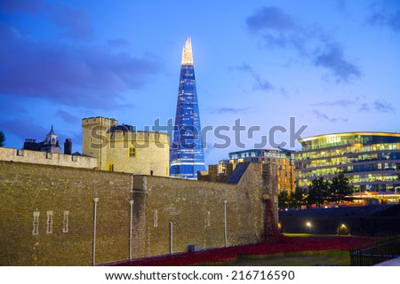 LONDON, UK - August 11, 2014: Shard of glass and office buildings in twilight. View form tower of London
