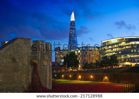 LONDON, UK - August 11, 2014: Shard of glass and office buildings in twilight. View form tower of London