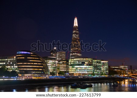 LONDON, UK - AUGUST 11, 2014: City of London and Shard of glass night panoramic view from the Tower bridge