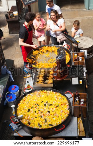 LONDON, UK - 22 JULY, 2014: Paella in Covent Garden market, one of the main tourist attractions in London, known as restaurants, pubs, market stalls, shops and public entertaining.